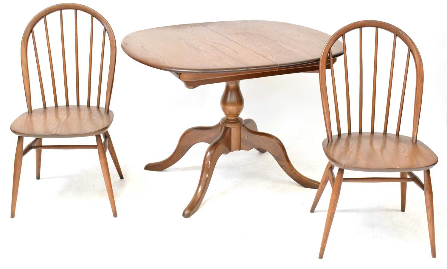 Lot 6 - ERCOL; a mid-coloured elm circular extending...