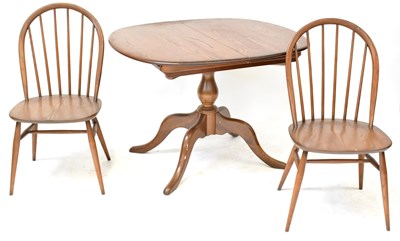 Lot 6 - ERCOL; a mid-coloured elm circular extending...