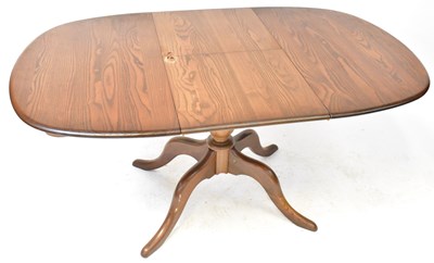 Lot 6 - ERCOL; a mid-coloured elm circular extending...