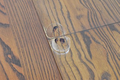 Lot 6 - ERCOL; a mid-coloured elm circular extending...