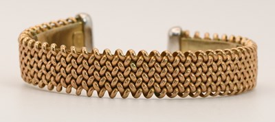 Lot 1538 - A 9ct yellow gold braided torque bangle, with...