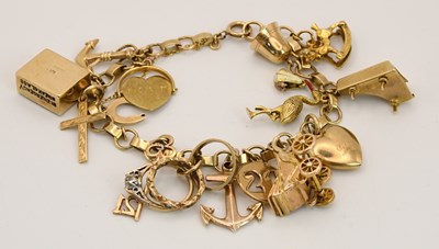 Lot 1535 - A 9ct yellow gold charm bracelet, suspending...