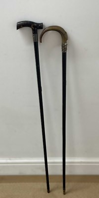 Lot 46 - Two ebonised walking sticks, one with a...