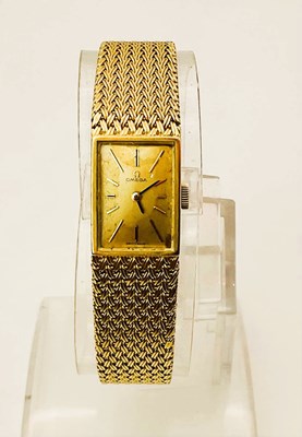 Lot 510 - OMEGA; a lady's gold bracelet watch with Omega...