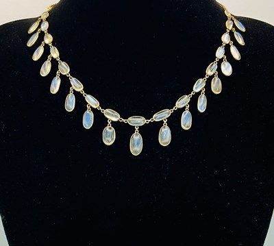Lot 454 - A 9ct yellow gold moon stone set tassel drop...