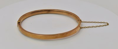 Lot 499 - A yellow metal snap bangle, diameter 6cm, 6.63g