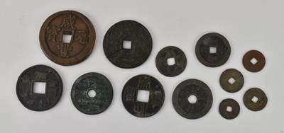 Lot 1671 - Twelve assorted Chinese and Japanese tokens,...