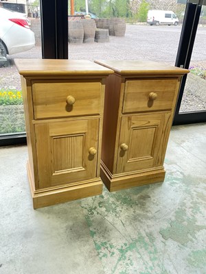 Lot 812 - A pair of pine bedside cabinets with left and...