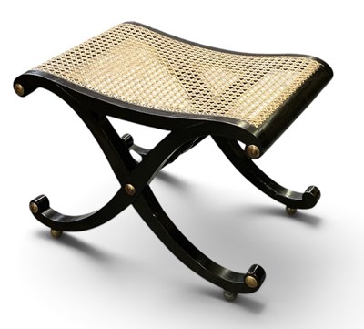 Lot 105 - A modern ebonsied X-frame bergere seated stool,...