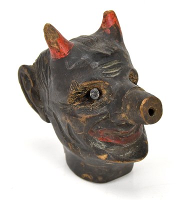 Lot 310 - A carved devil pipe bowl, height 8cm.