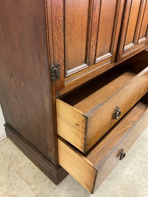 Lot 755 - An oak tall boy, the cupboard with internal...