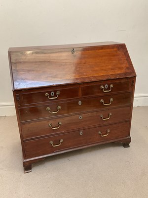 Lot 138 - A George III mahogany bureau, the crossbanded...