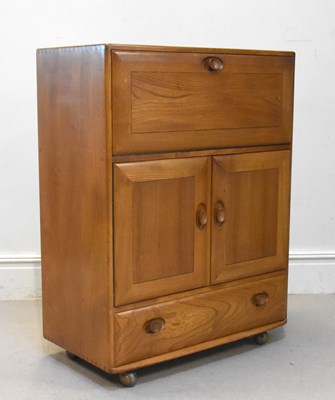 Lot 9 - ERCOL; a medium elm cocktail/drinks cabinet,...