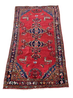 Lot 680 - A Persian rug with floral border, two central...