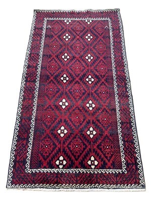 Lot 681 - A Persian rug with a repeating geometric...