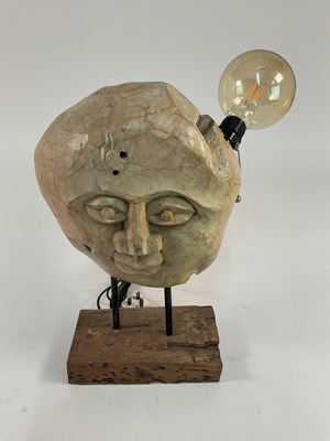 Lot 608 - A unusual carved wooden head, raised on a...