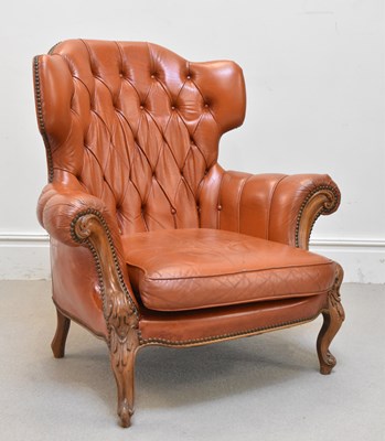 Lot 1155 - A large Chesterfield type wing armchair with...