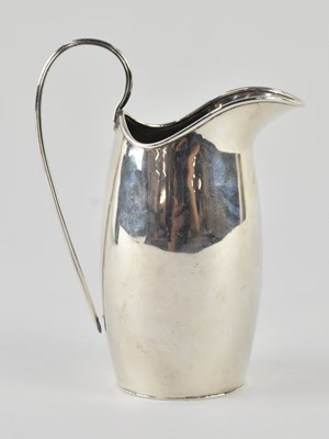 Lot 1215 - A George III style white metal cream jug,...