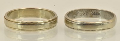 Lot 1358 - A pair of 18ct white gold band rings, both...