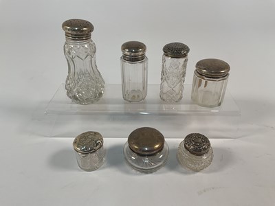 Lot 559 - A collection of seven hallmarked silver topped...
