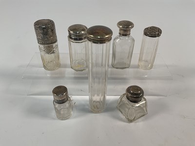 Lot 560 - A collection of seven hallmarked silver topped...