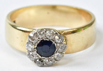 Lot 754 - A 9ct yellow gold ring set with a central blue...