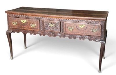 Lot 19 - A 19th century carved oak three drawer dresser...
