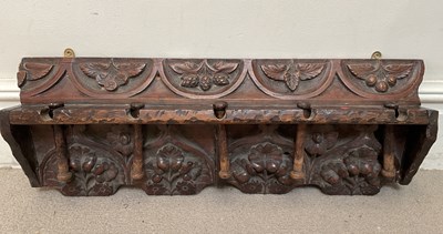 Lot 63 - A late 19th century carved oak coat rack, with...