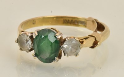Lot 1402 - A 9ct yellow gold emerald and paste set three...
