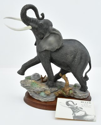 Lot 134 - FRANKLIN MINT; a large porcelain figure of an...