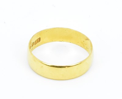 Lot 769 - A 22ct yellow gold band ring, size N, approx....