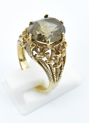 Lot 755 - A 9ct yellow gold smoky quartz set dress ring,...
