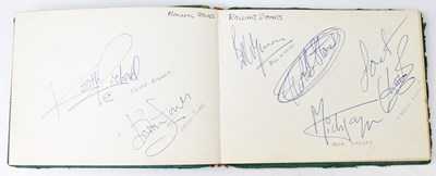 Lot 303 - A vintage green autograph book containing a...