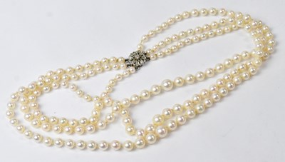 Lot 794 - A three-strand pearl necklace with a 9ct white...