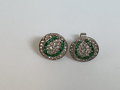 Lot 572 - A pair of white metal emerald and diamond...