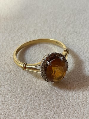 Lot 575 - An 18ct yellow gold oval dress ring set with...