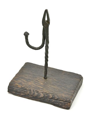 Lot 367 - A Welsh wrought iron rushlight, on oak plinth,...