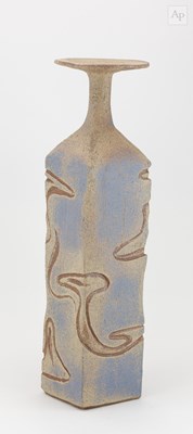 Lot 696 - A tall square stoneware bottle with disc rim...