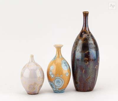 Lot 682 - A graduated trio of porcelain bottles with...