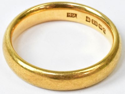Lot 765 - An 18ct yellow gold wedding band, marked 18,...
