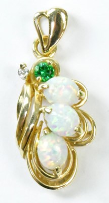 Lot 809 - A 14ct yellow gold pendant set with three oval...