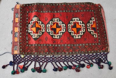 Lot 187 - An Eastern saddle bag with stylised detail on...