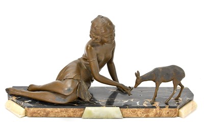Lot 448 - An Art Deco spelter figure group of a maiden...
