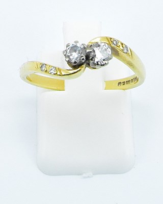 Lot 766 - An 18ct yellow gold diamond set crossover ring,...