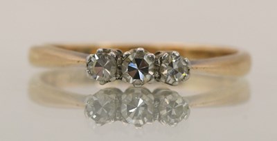 Lot 1424 - A 9ct yellow gold three stone diamond set ring,...