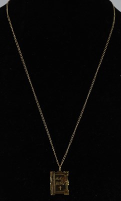 Lot 1493 - A 9ct yellow gold bible shaped pendant, with...