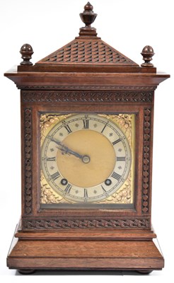 Lot 71 - An Edwardian carved oak eight-day mantel clock,...