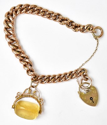 Lot 775 - A 9ct gold curb link bracelet with...