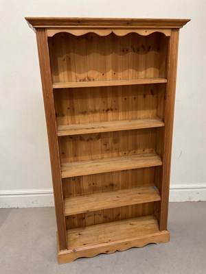 Lot 37 - A modern pine open bookcase, on plinth base,...