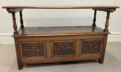 Lot 53 - A 1920s carved oak monk's bench, width 111cm.